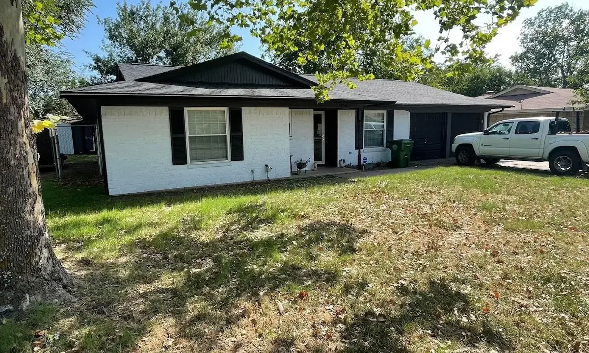 Professional roofing crew working on a residential roof in Kinston